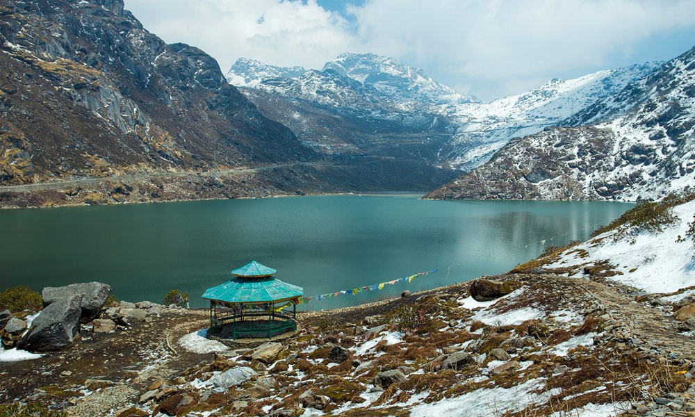 Tsomgo Lake with turquoise glacial waters and snow-capped peaks in Sikkim